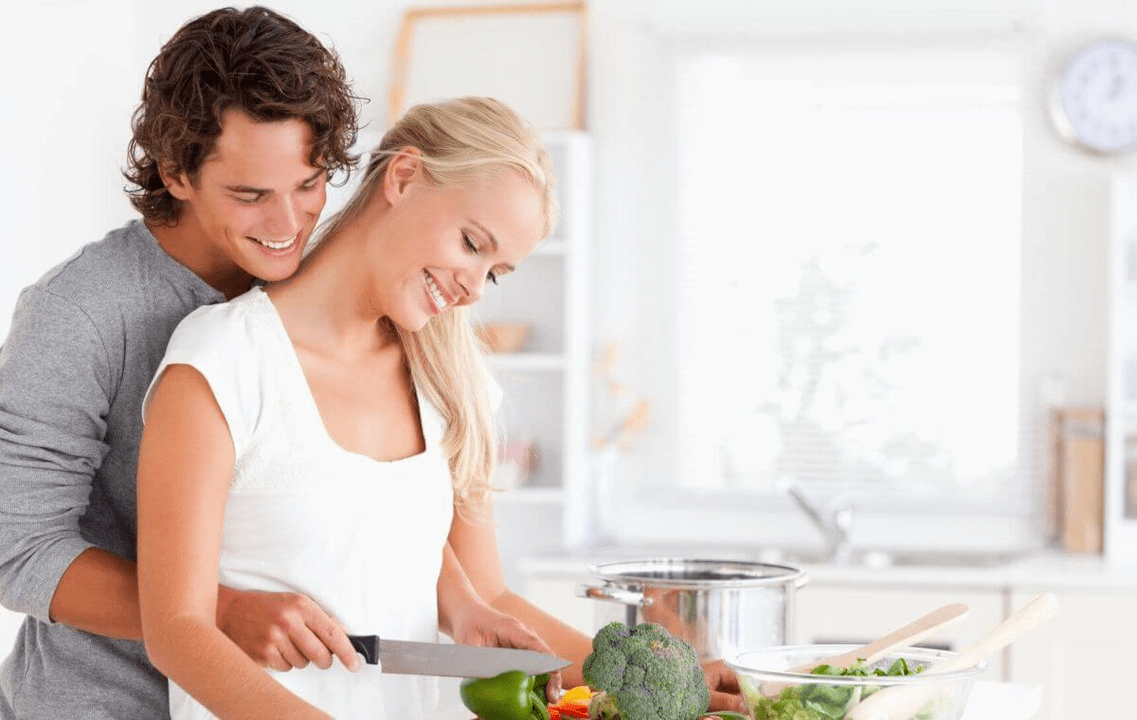 A young couple cook